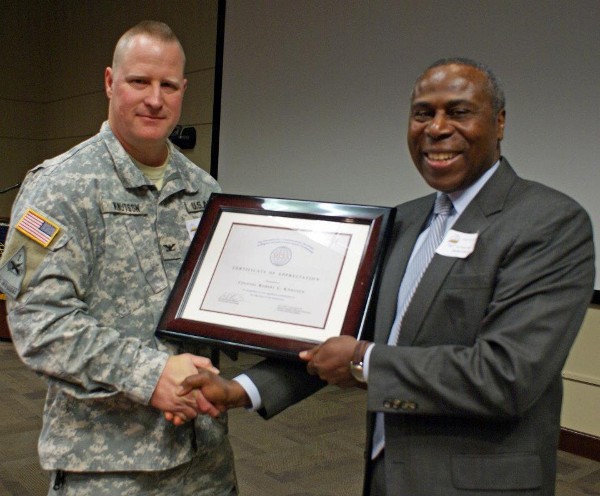 Col. Robert C. Knutson, USA (l), director, Personnel Information Systems Directorate, U.S. Army Human Resources Command, receives a Speaker's Appreciation Award from Freddie Blakely, chairman of the chapter's board, at the April meeting.